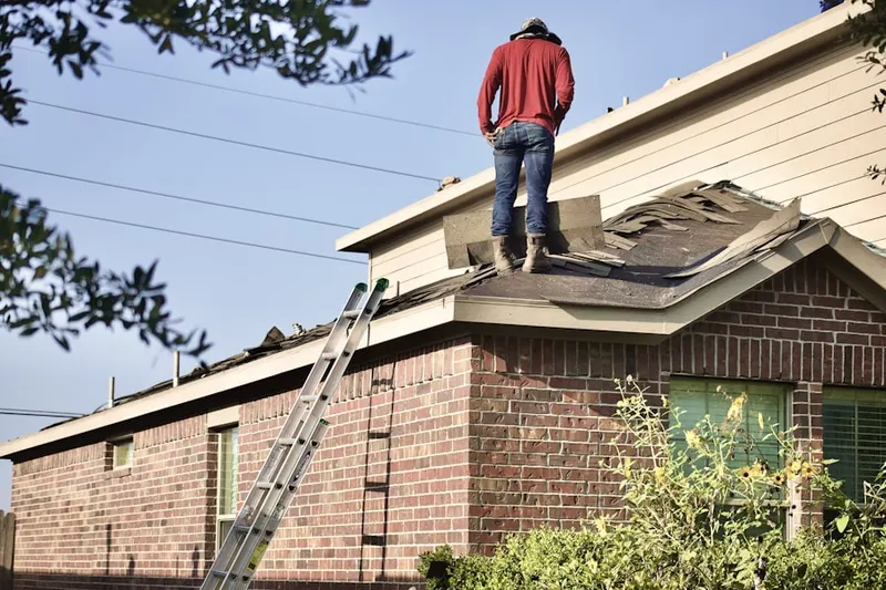 Professional roofer working on a residential roof in Cable-Westwood